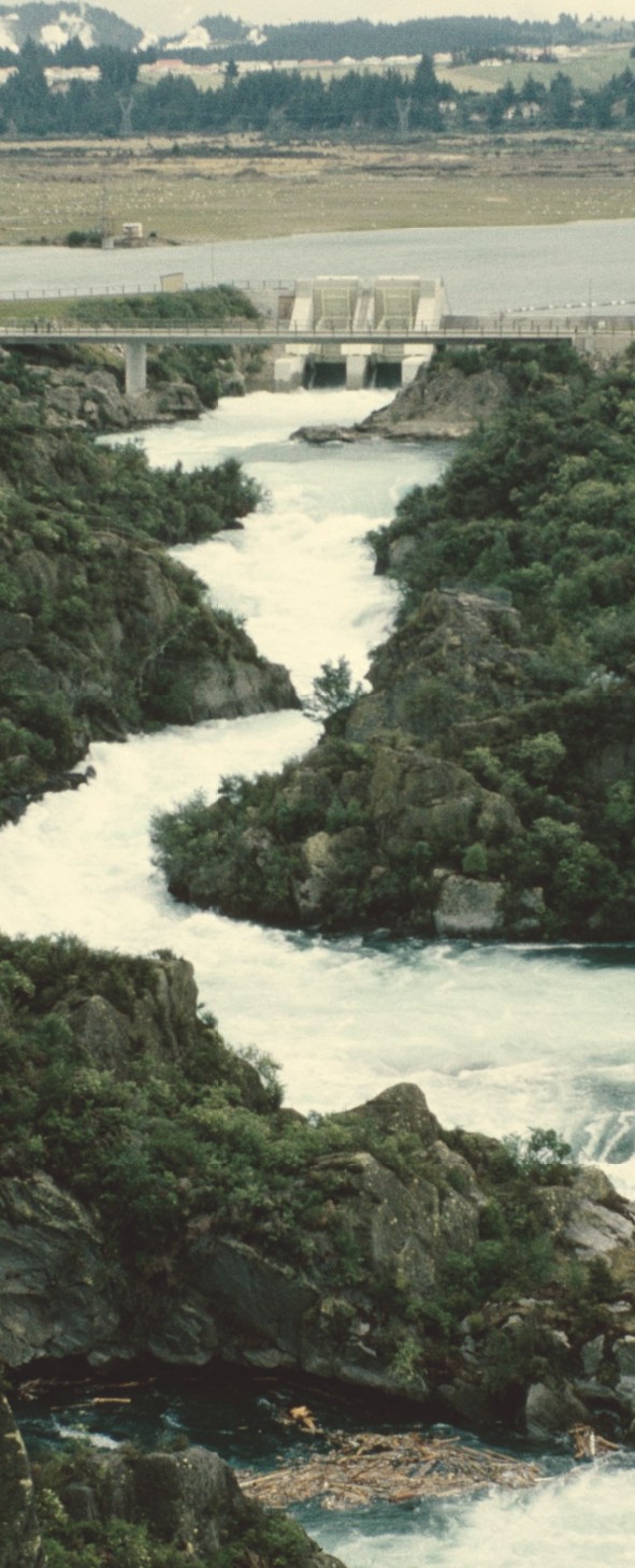 River running between rocks below a dam